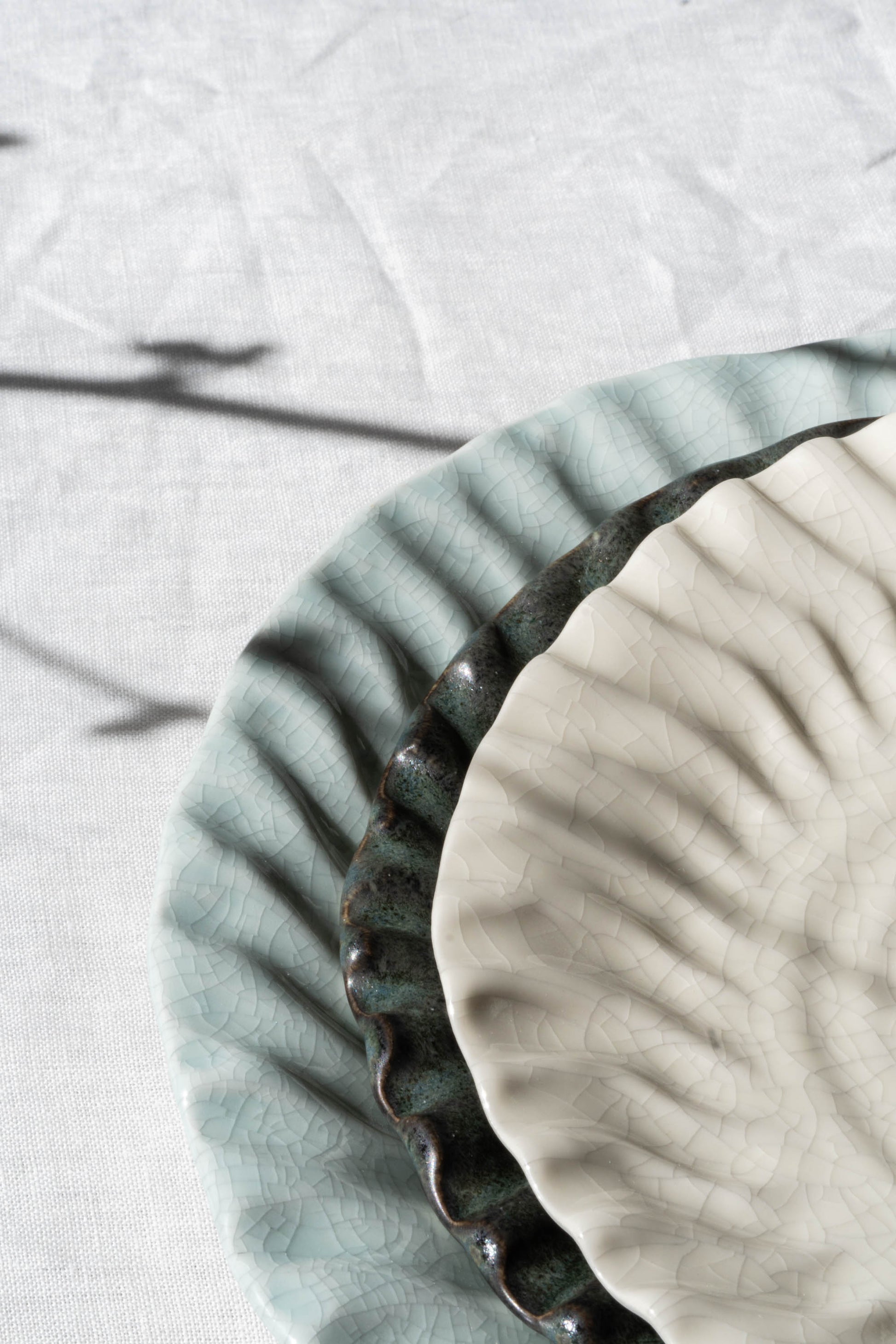 Stack of Dashi Plates on white tablecloth.