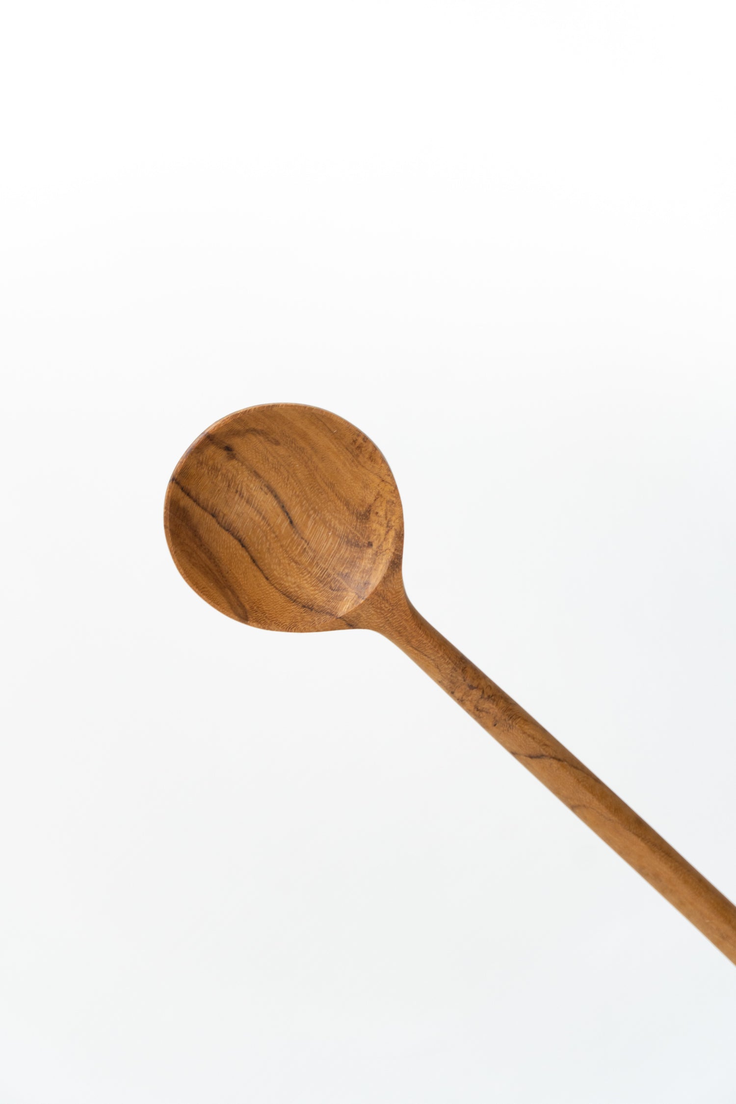Close-up of the Wooden Slim Spoon by The Loft Selects.