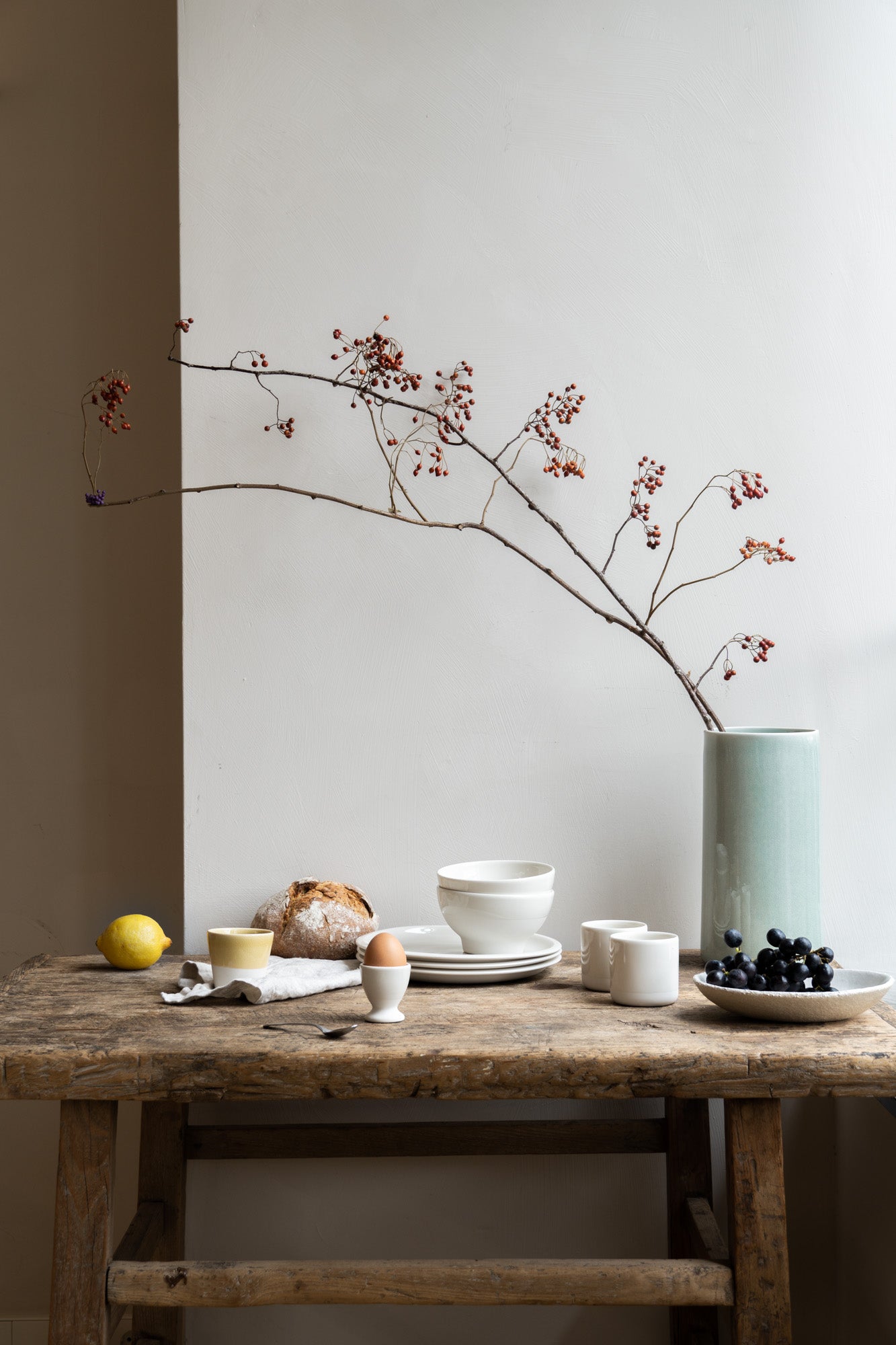 Table set for breakfast, with bread, lemon and egg.