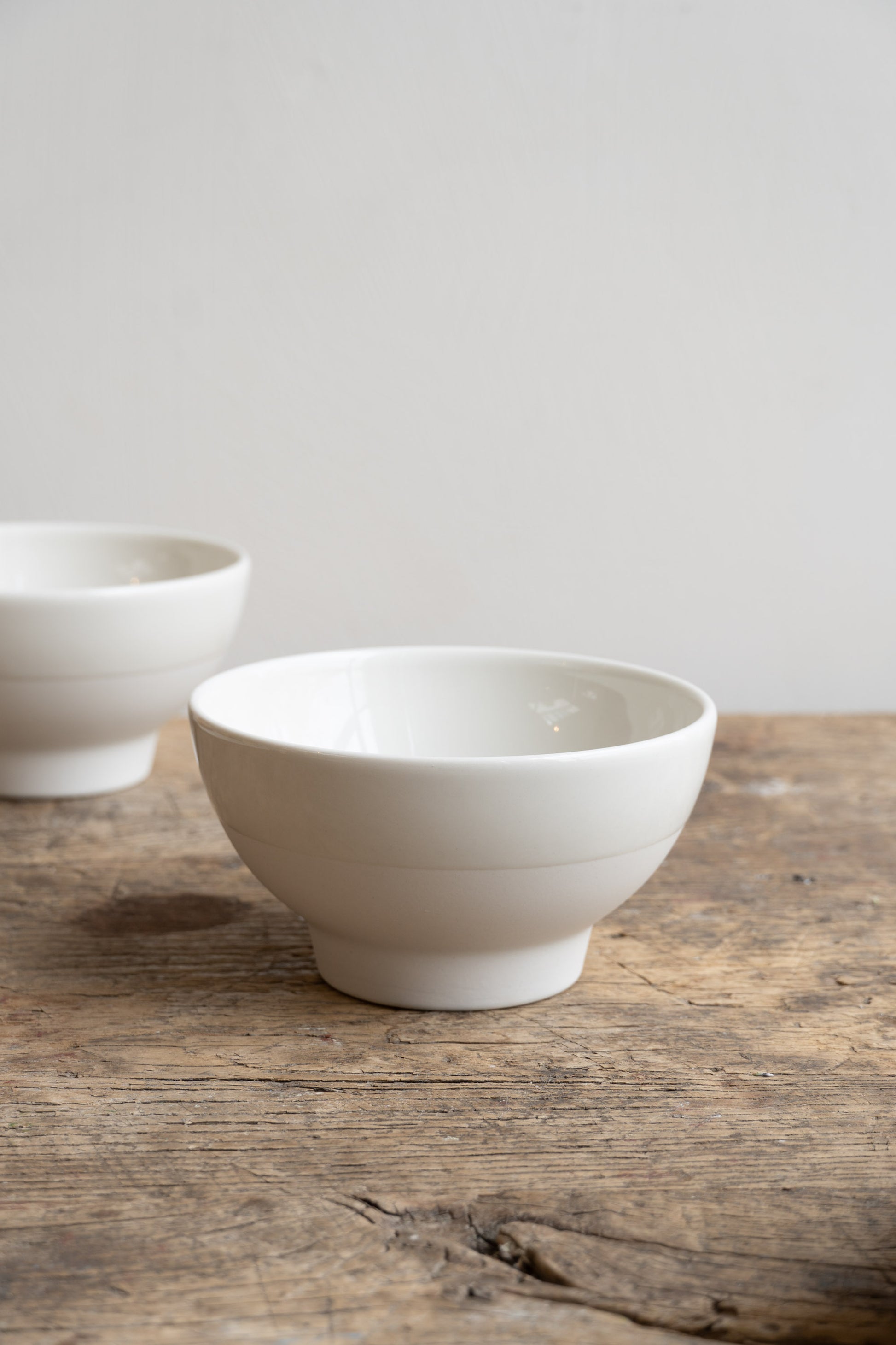 Alternate view of the two Antibes bowls on wooden table.