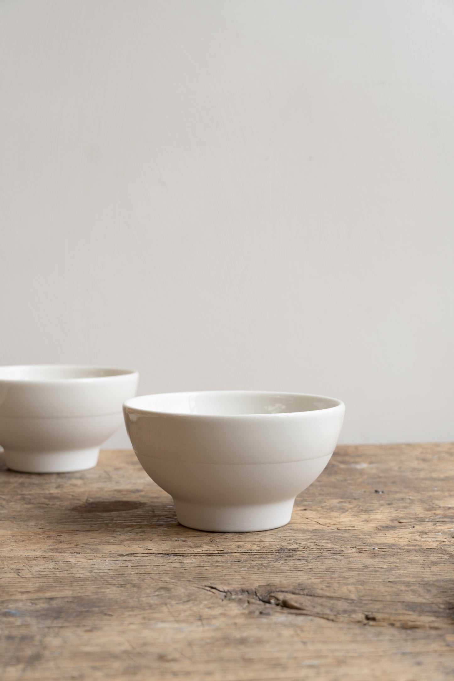Jars Antibes Bowl White by Jars Ceramistes. Two bowls on wooden table.