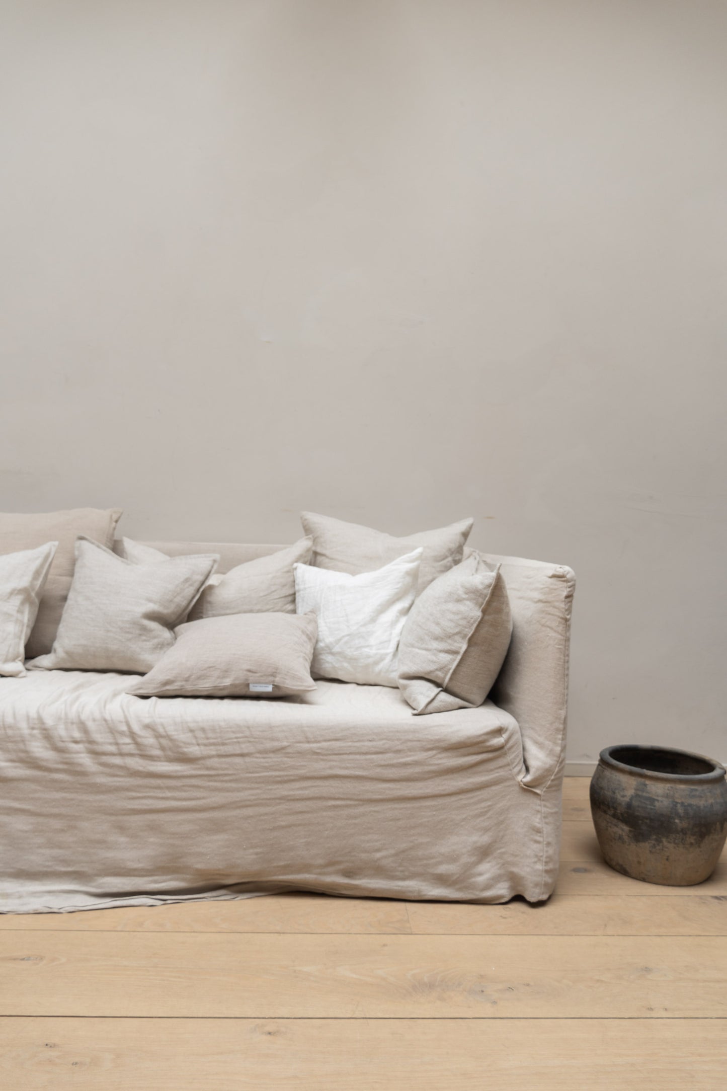 Linen Cushions by Timeless Linen set on couch in a light and neutral interior at Enter The Loft.