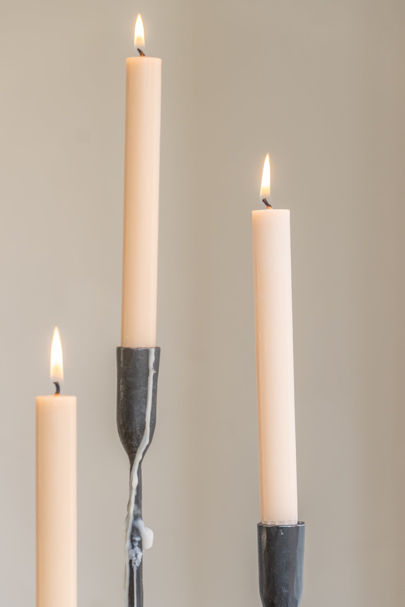 Dinner Candles Beige on candle pin holders.