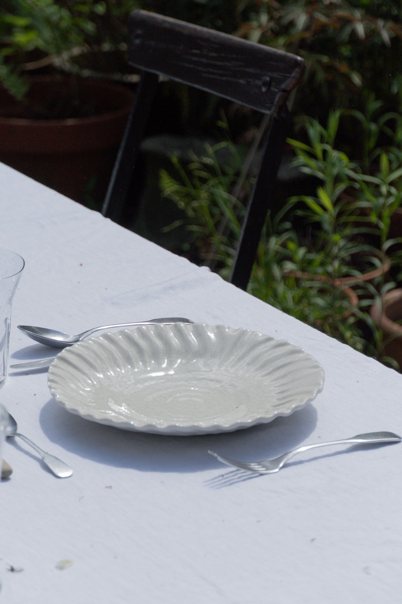 White Crackled Glaze Dashi Plate on table outdoors.