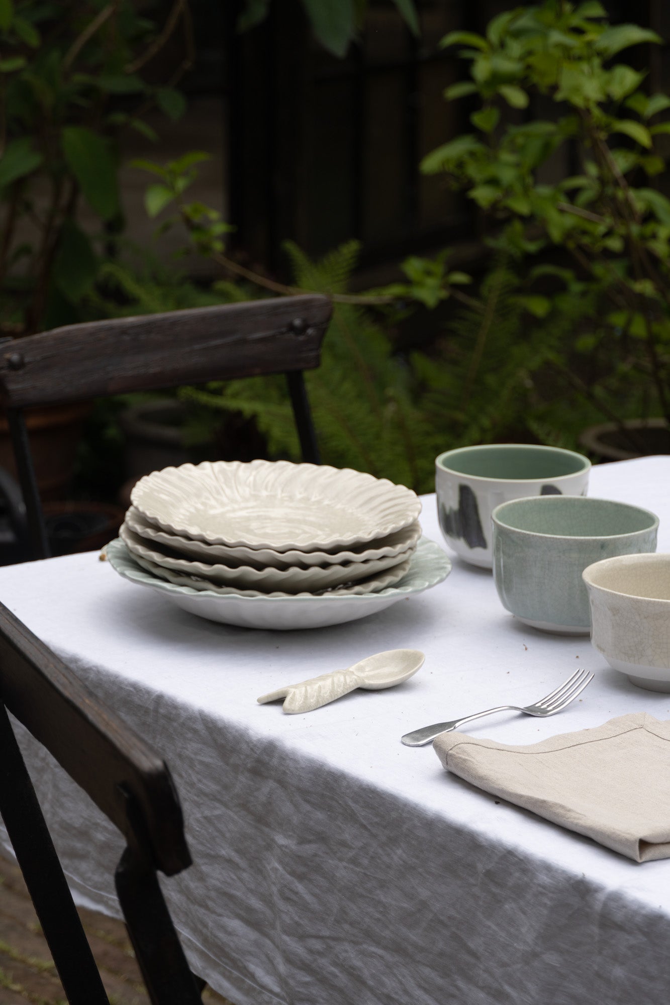 Outdoors table setting with items from Jars Ceramistes.