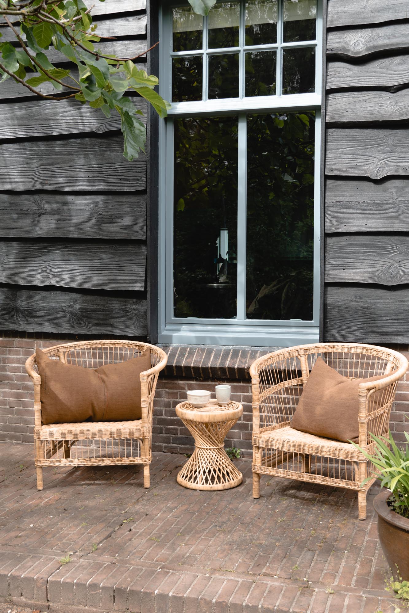 Rattan Lounge Set by Tine K Home set in front of a lovely wooden panelling home.
