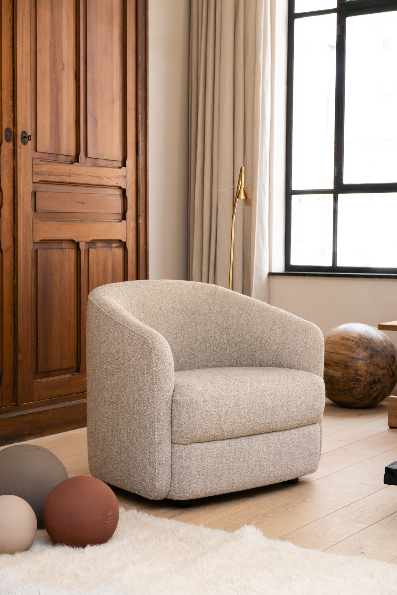 Side view Covent Lounge Chair set in a light and neutral interior at Enter The Loft.