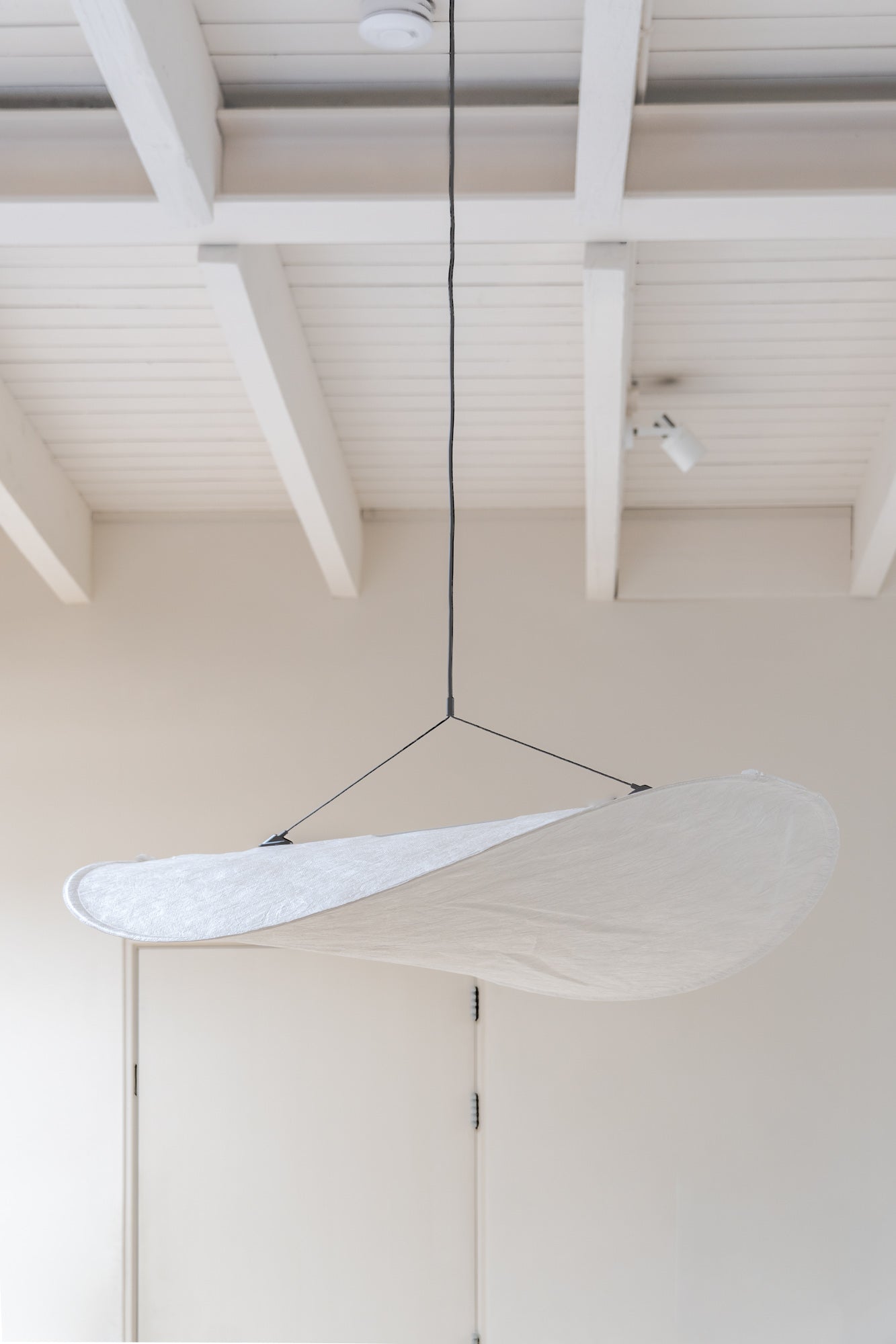 Tense Pendant Lamp by New Works in light and open interior.