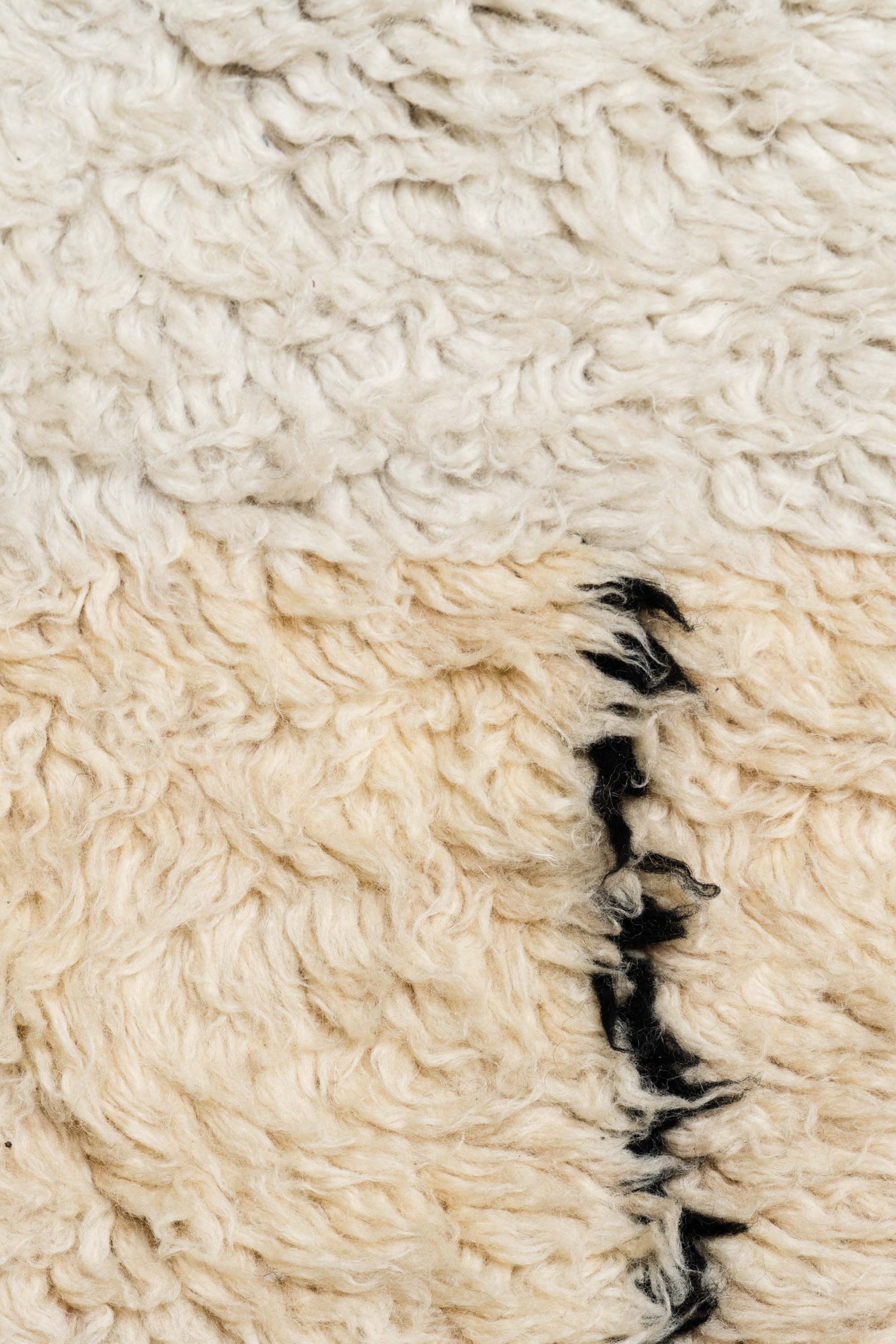 Close-up of the E La Nave Va Rug by Zakaria Rugs.