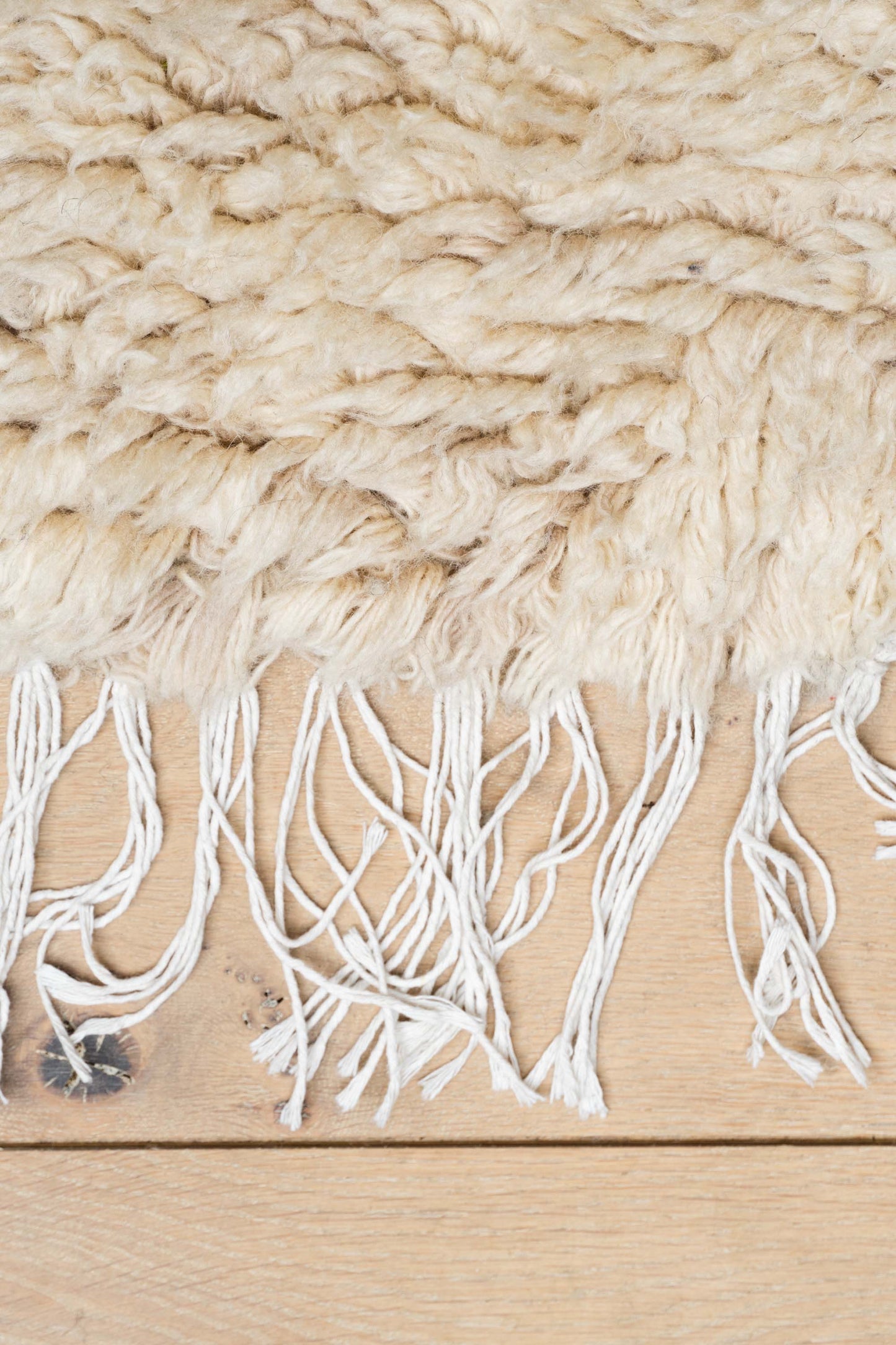 Close-up of the fringes on the E La Nave Va Rug by Zakaria Rugs.