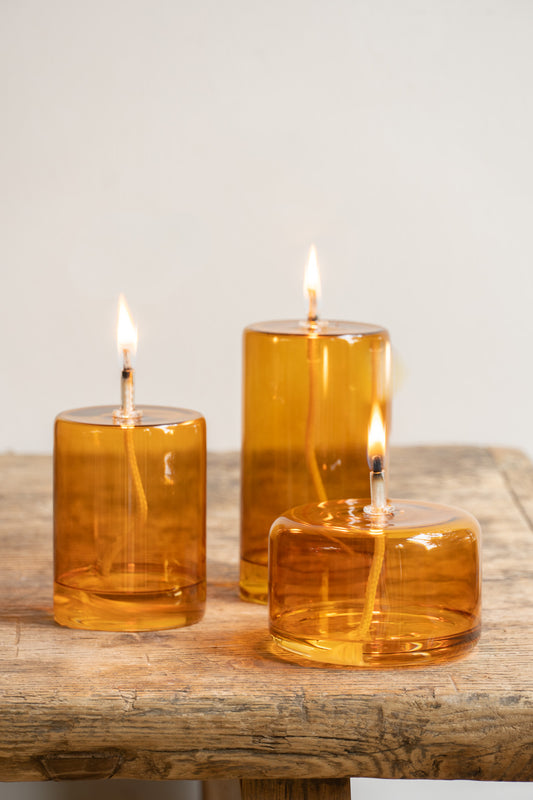 ENO Studio Coloured Glass Oil Lamps - amber orange with lit wick