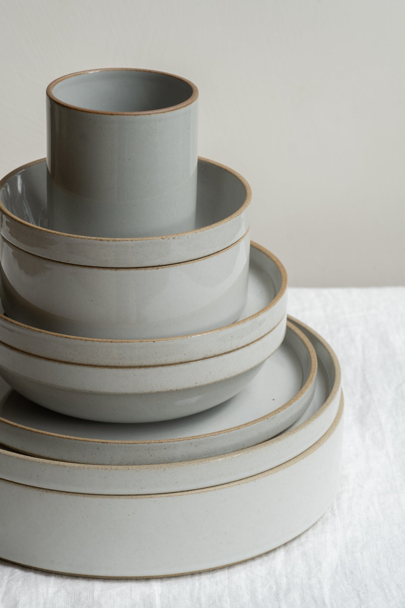 Hasami Porcelain stackable tableware set in grey set on white linen table cloth.
