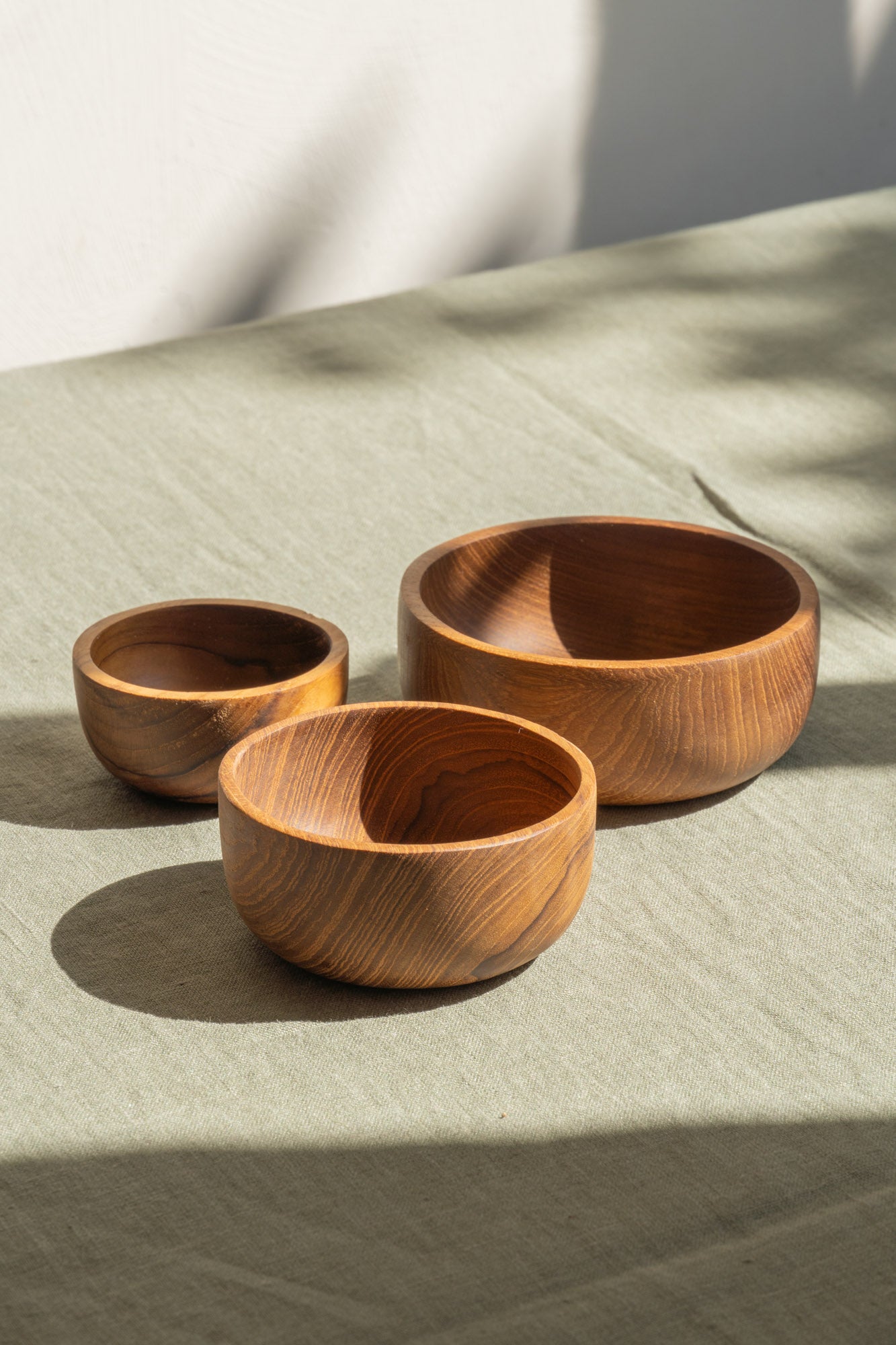 Three sizes of the Nibble Wooden Bowls by The Loft Selects.