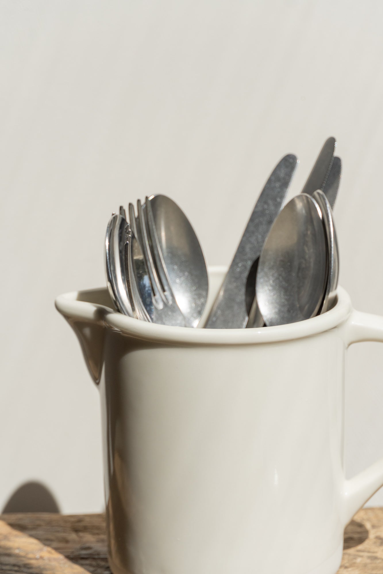 Close-up of the Roussillon Carafe White by Jars Ceramistes used as utensil holder.