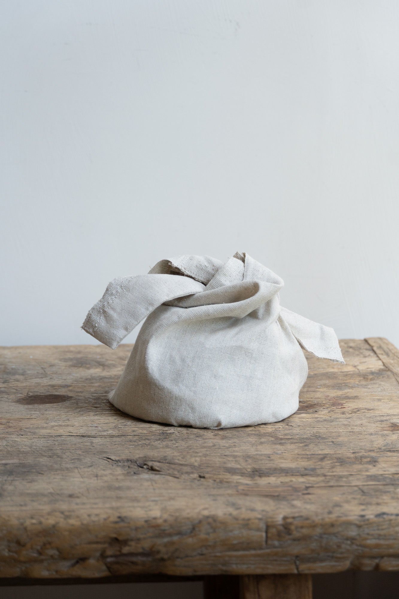 Linen Storage Bag by Bonni Bonne set on wooden table