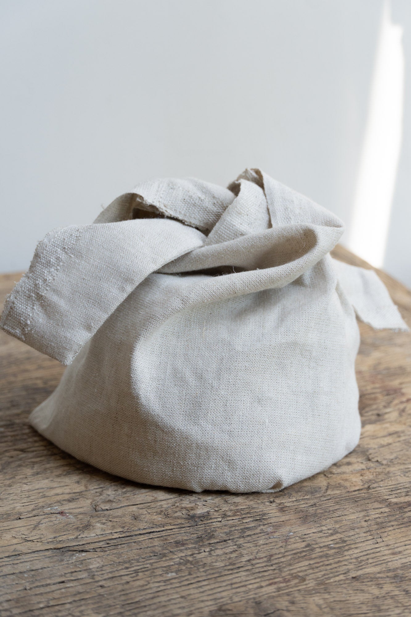 Linen Storage Bag by Bonni Bonne set on wooden table