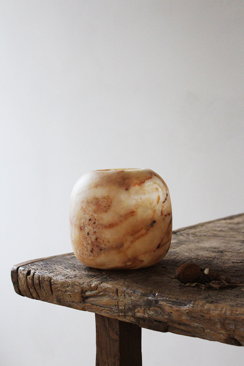 Close-up of the Alabaster Tealight Amber by The Loft Selects.