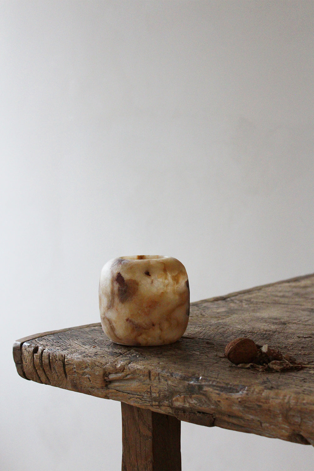 Alabaster Tealight Amber set on wooden table.