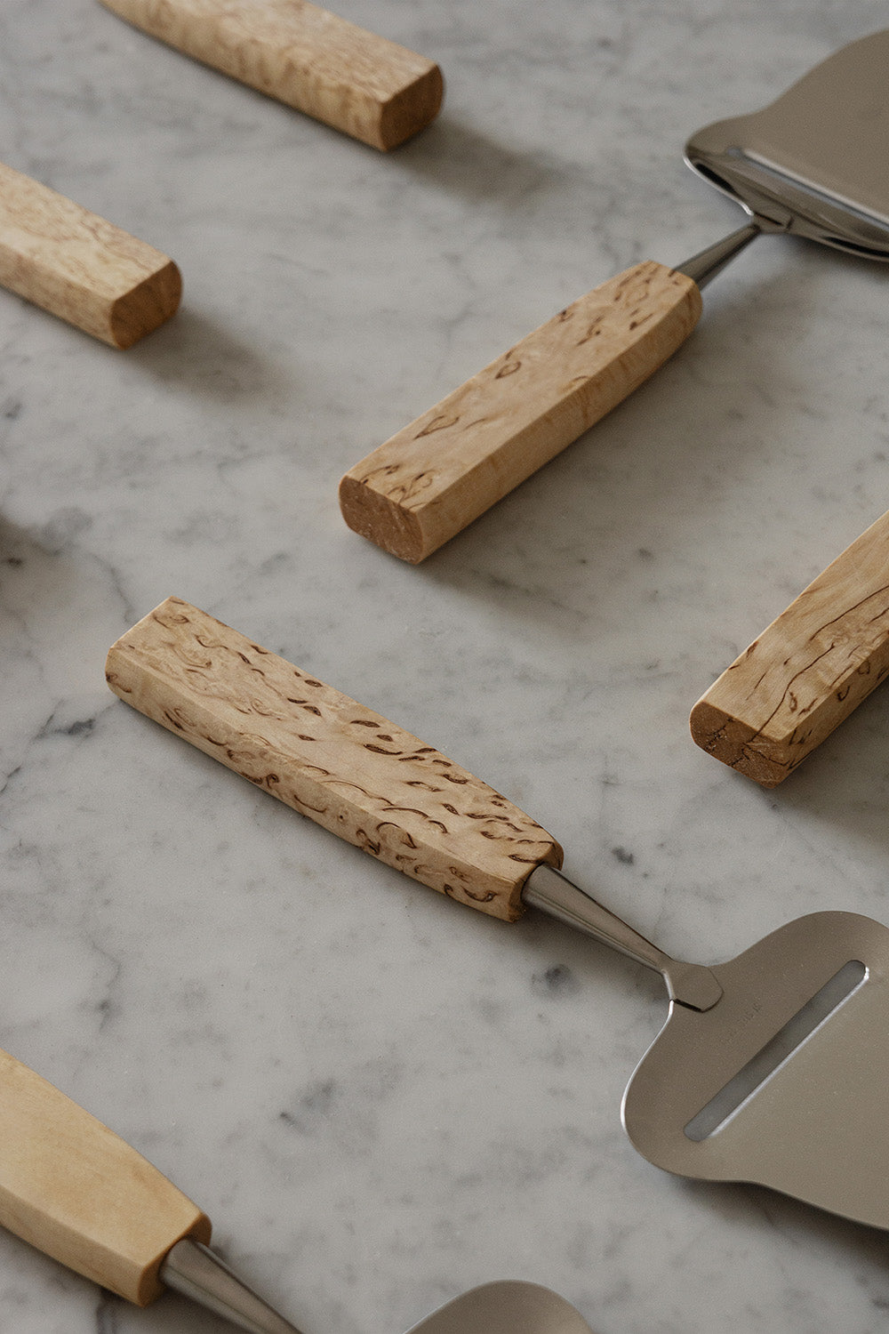 Birch Wood Cheese Slicers, positioned on marble background, by Bonni Bonne
