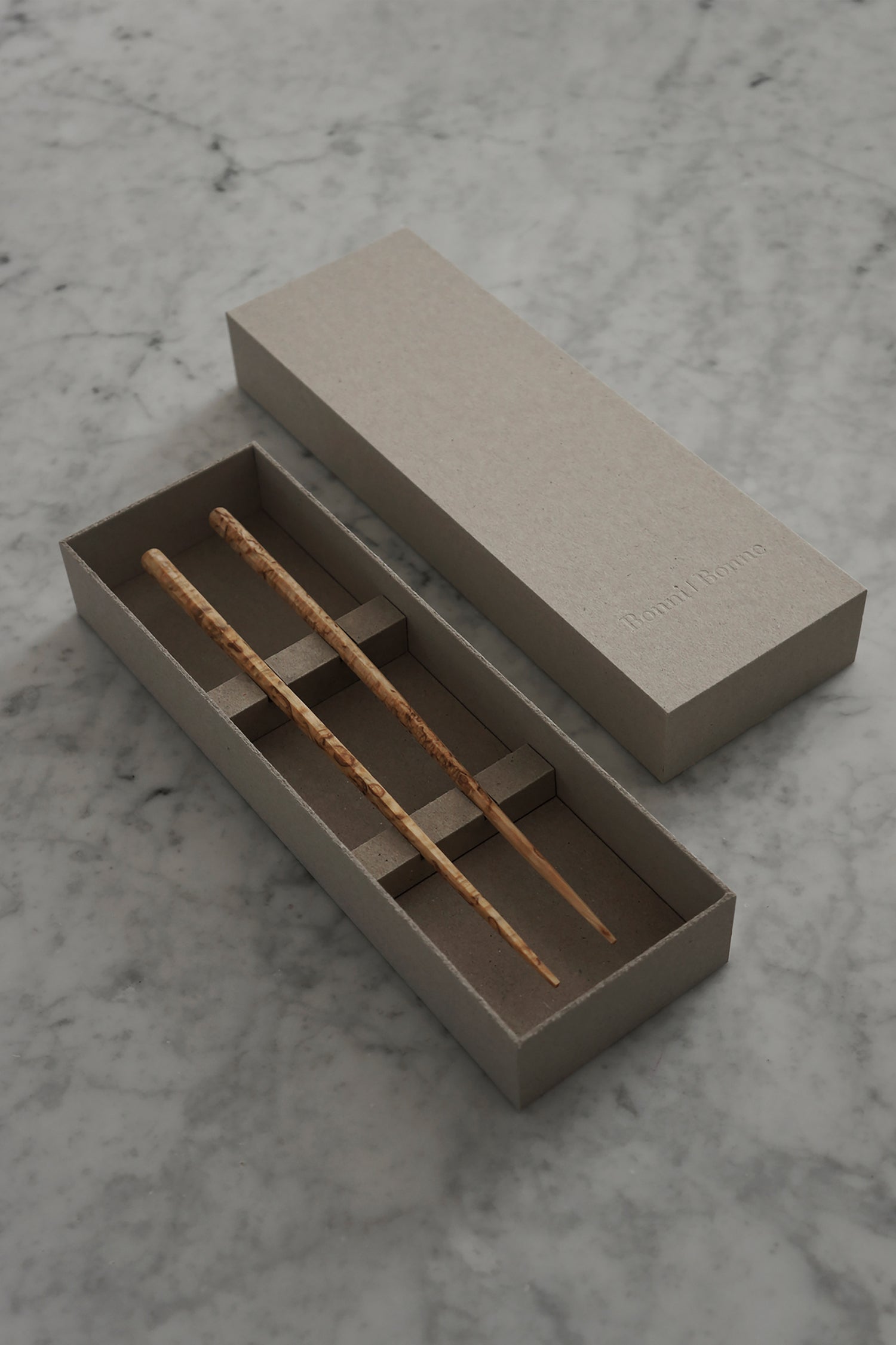 Handmade chopsticks on a marble background with giftbox packaging by Bonni Bonne