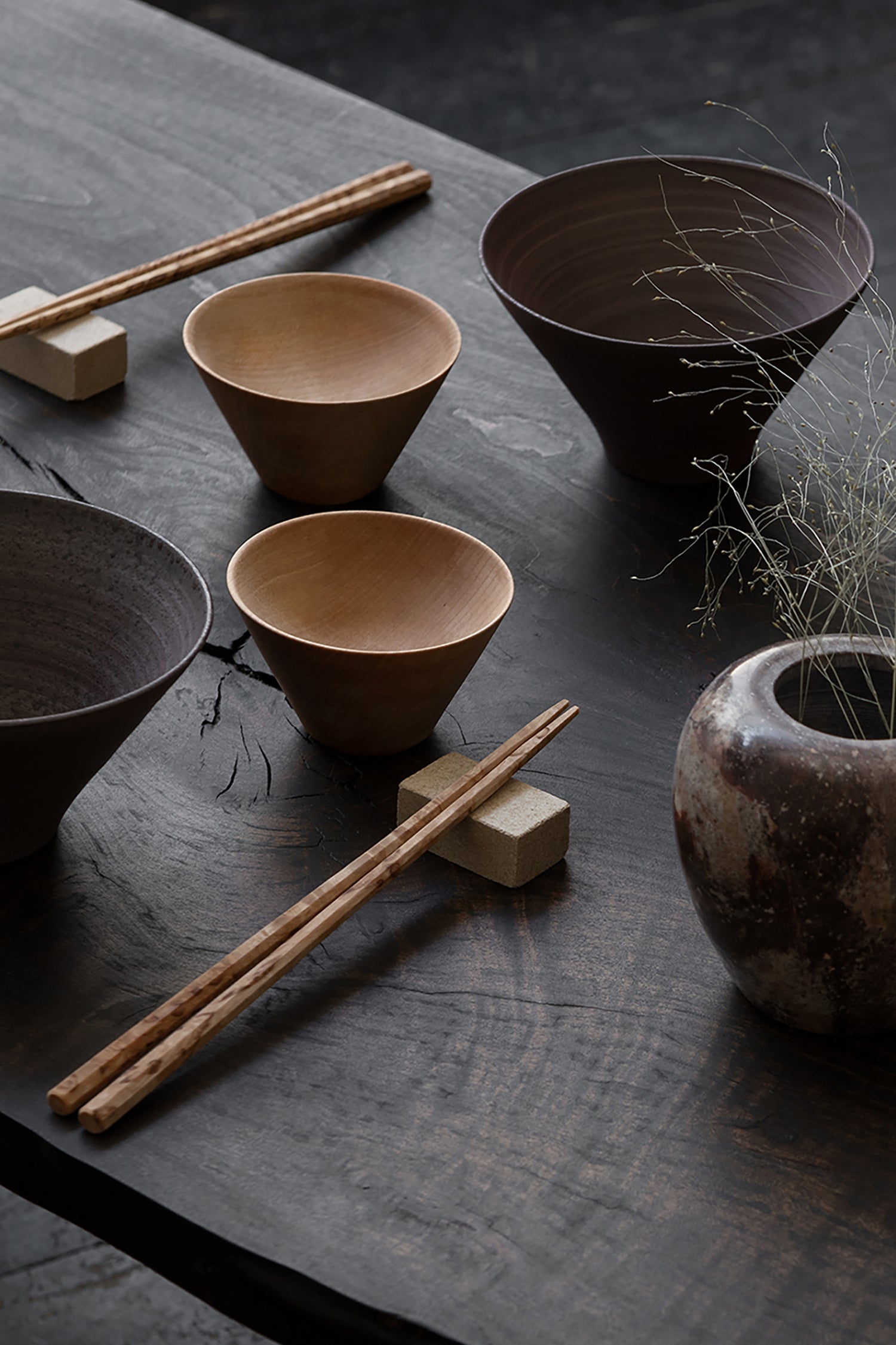 A Japanese styled table setting with chopsticks and wooden bowls by Bonni Bonne