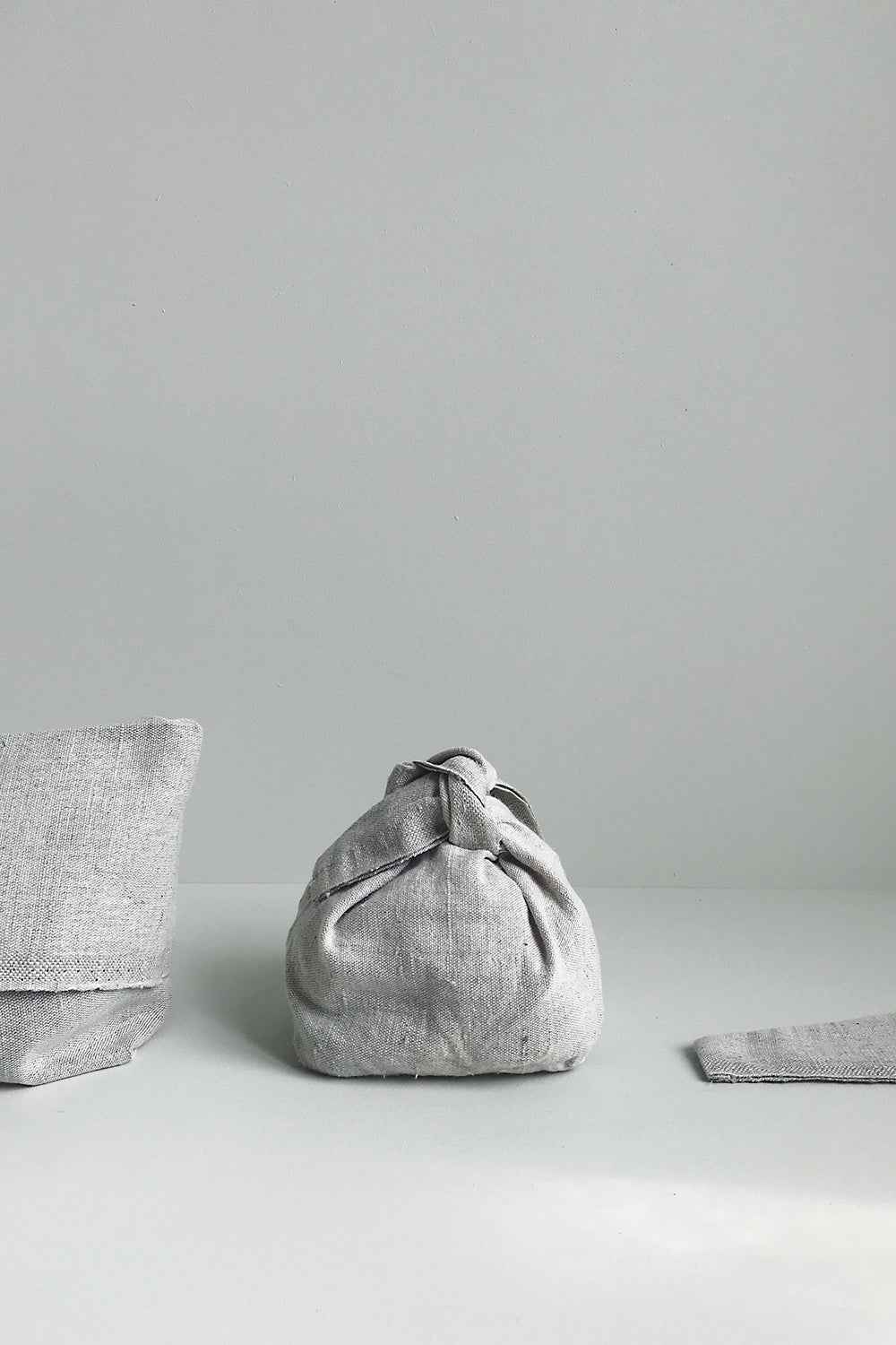 Linen storage bags on light background