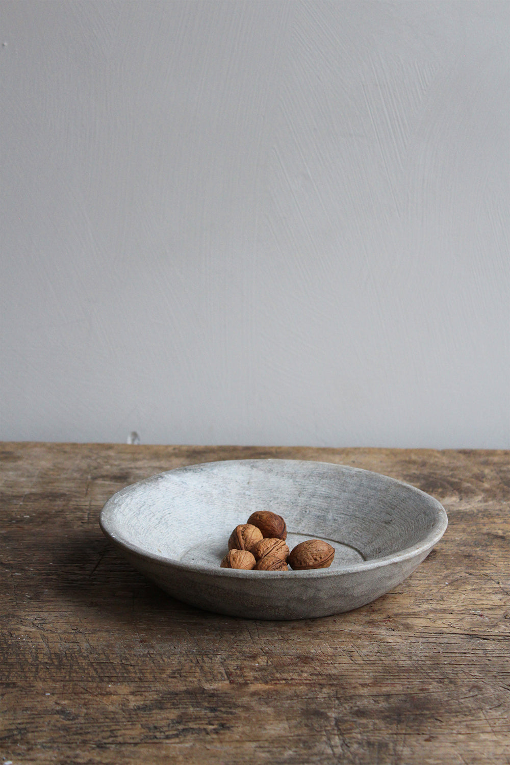 Mun Stone Bowl Small by The Loft Selects on wooden table.