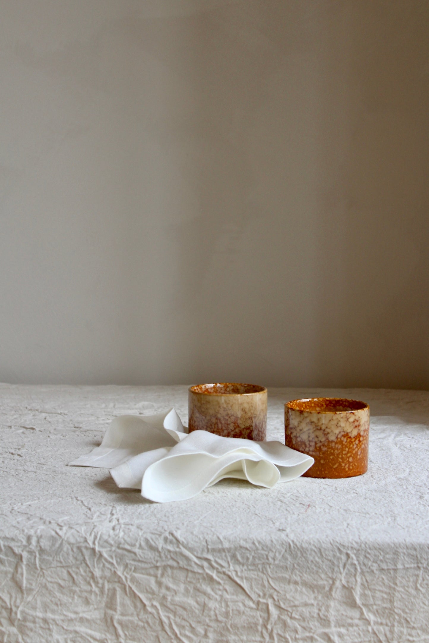 Two Kera Candles set on white linen table cloth