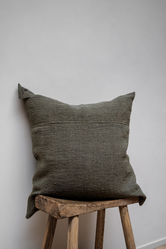 Chanvre Vintage - Olive Green Cushion by Isabelle Yamamoto set on a wooden stool.