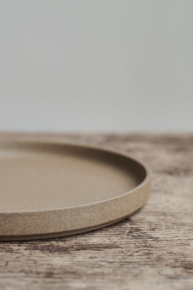 Close-up of the Hasami Porcelain Ceramic Japanese Stackable Plate Natural Clay on a rustic wooden table.