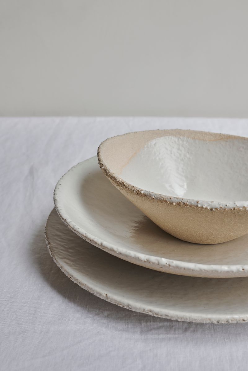 Stack of Wabi Plates and Textured Bowl by Jars Ceramistes.