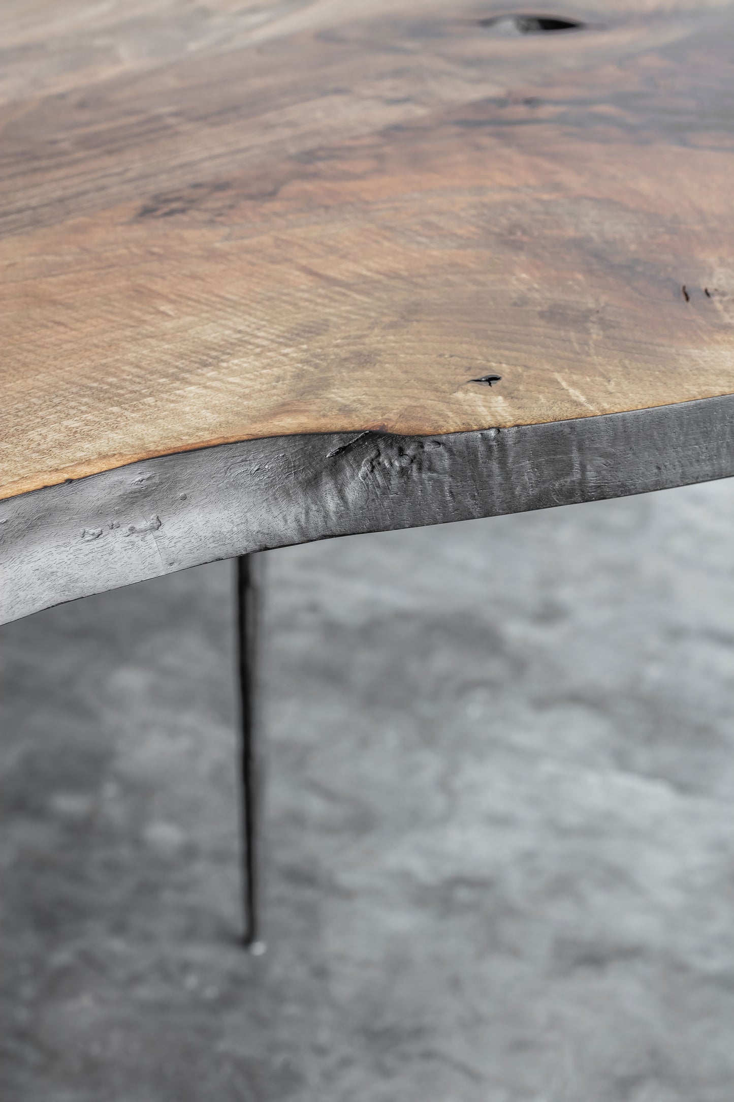 Side view of the Heerenhuis Lars Zech Coffee Table - Made from long textured thick walnut wood.