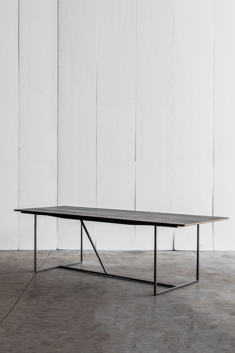 Mesa Nero Table by Heerenhuis made from Oak wood with a steel base.