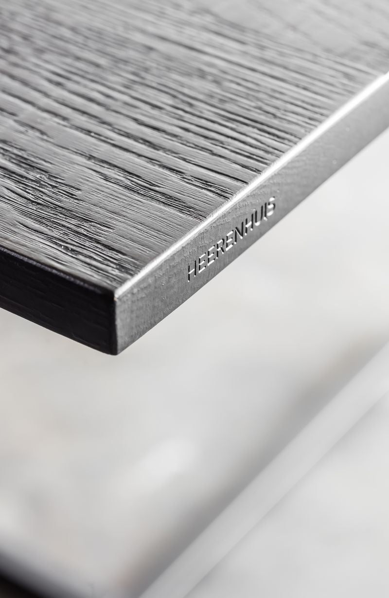 Heerenhuis logo engraving in the black oak wooden Mesa Nero Table