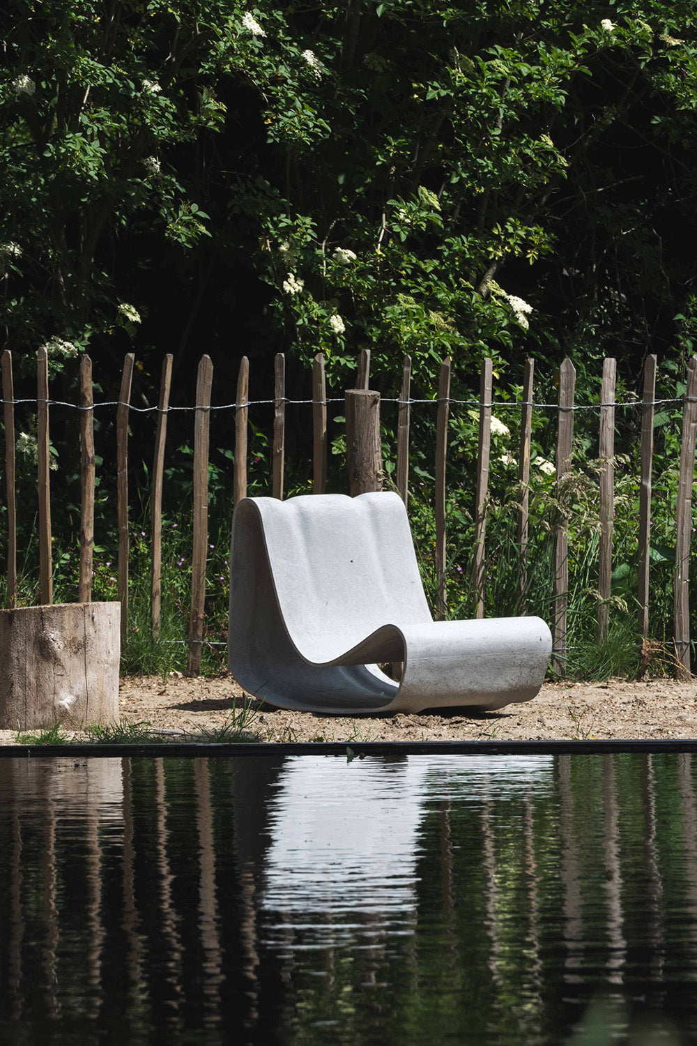 The Loop Chair by Willy Guhl seen at waterfront outside lounge area.