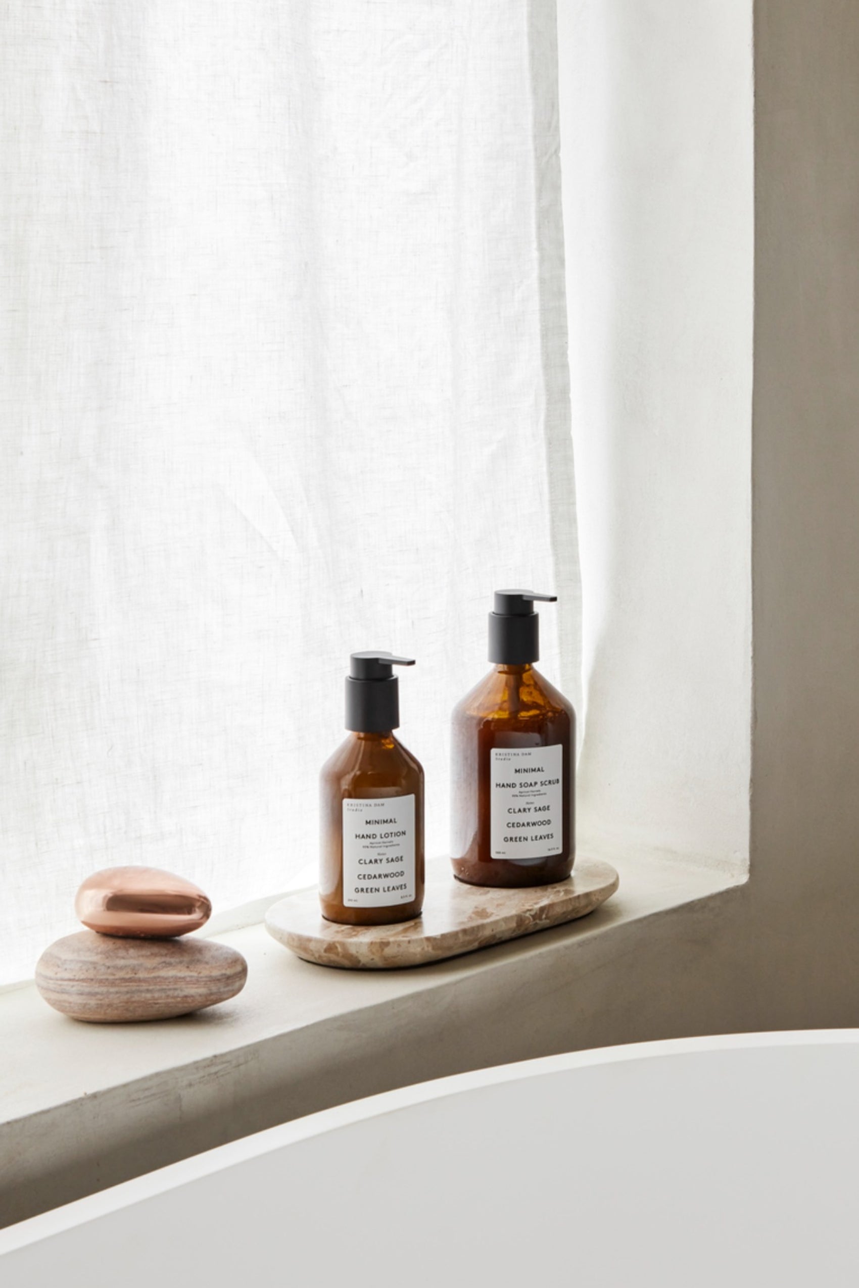 Marble Bottle Tray by Kristina Dam set in a light and airy bathroom interior.