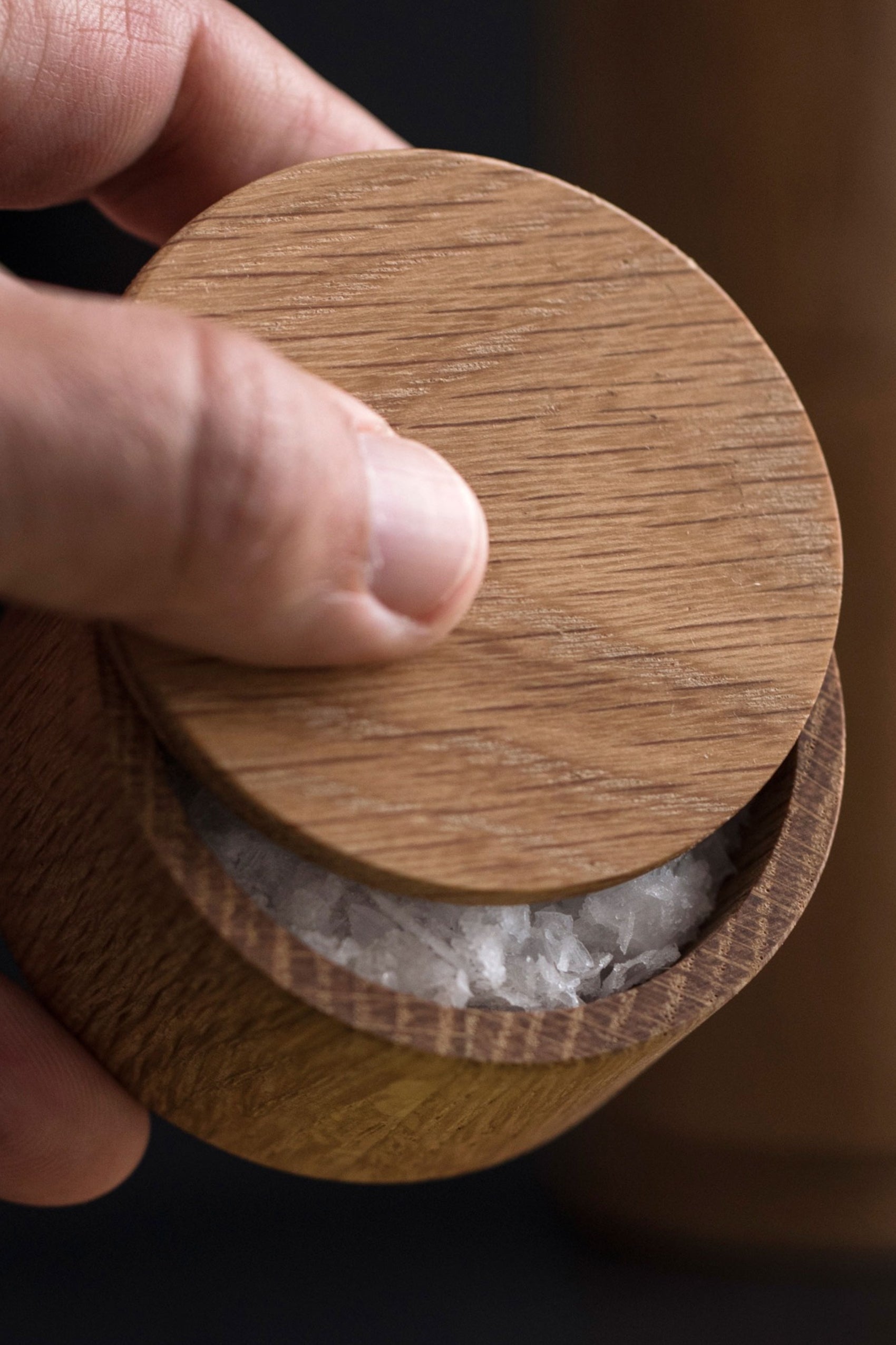 Salt Me in use, salt being poured from the wooden container. EKTALIVING adds functionality and visual appeal to any dining experience.