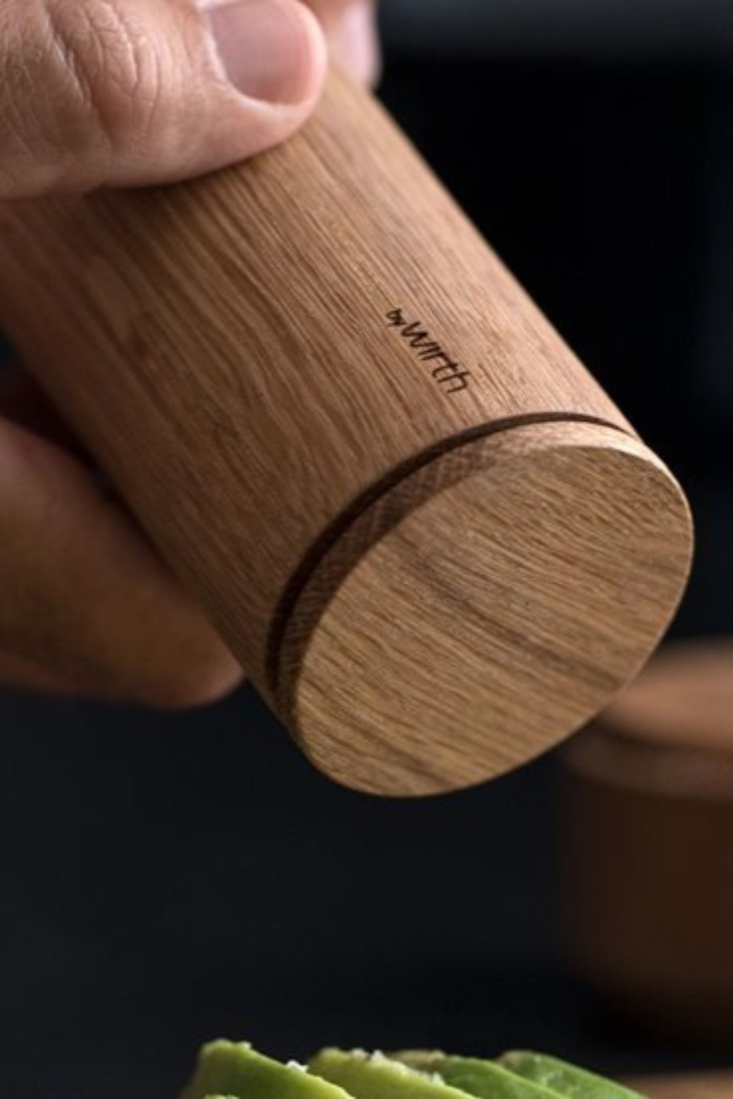 Detail of the wooden Crush Me Pepper grinder by EKTA Living  in use.
