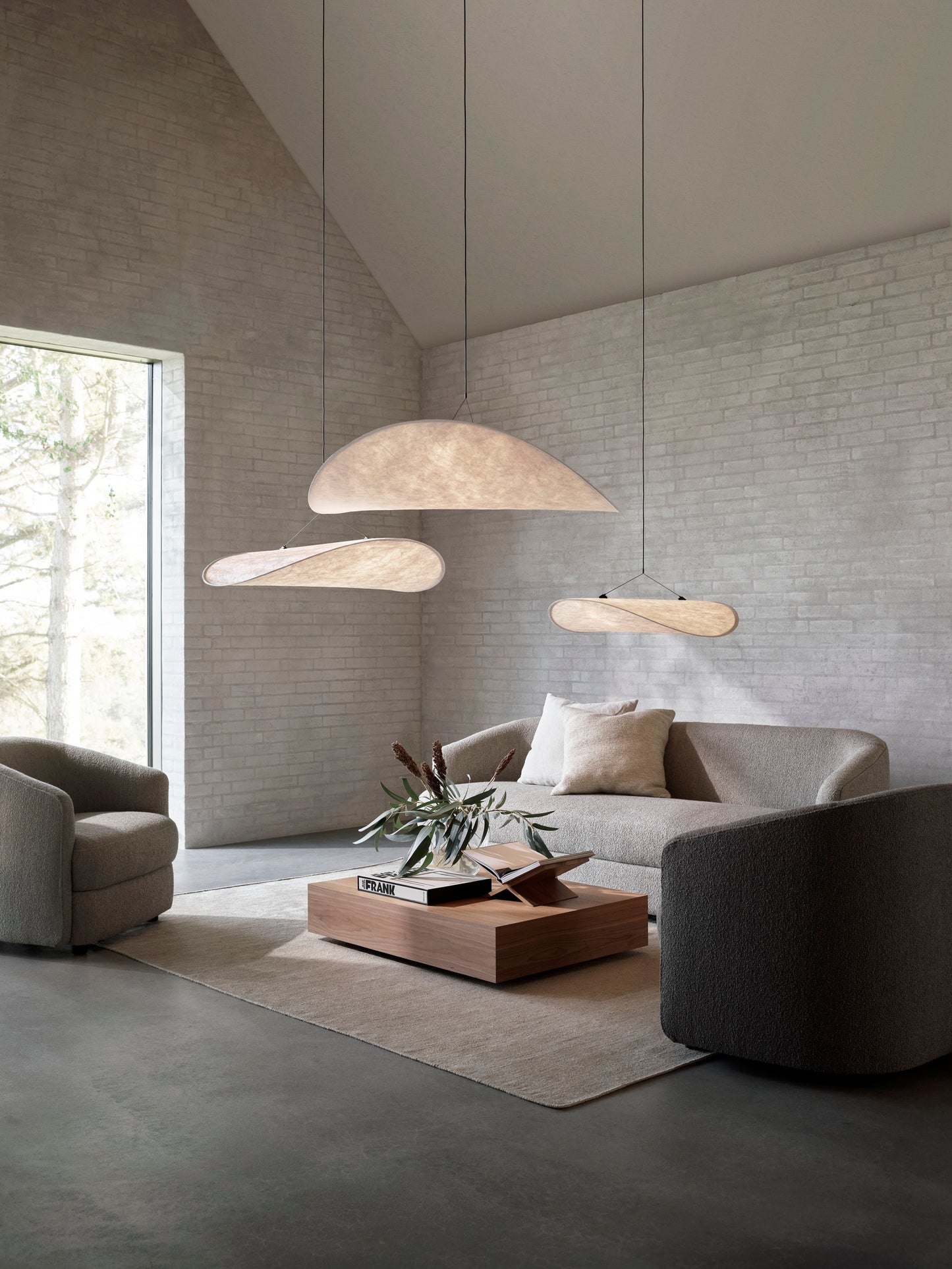 Tense Pendant Lamps by New Works hanging in modern design interior living room with Covent Sofa and Chairs.