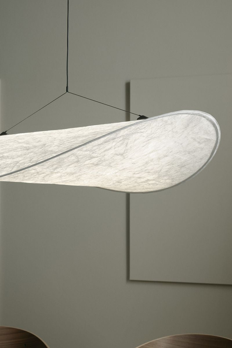 Tense Pendant Lamp by New Works, light on.