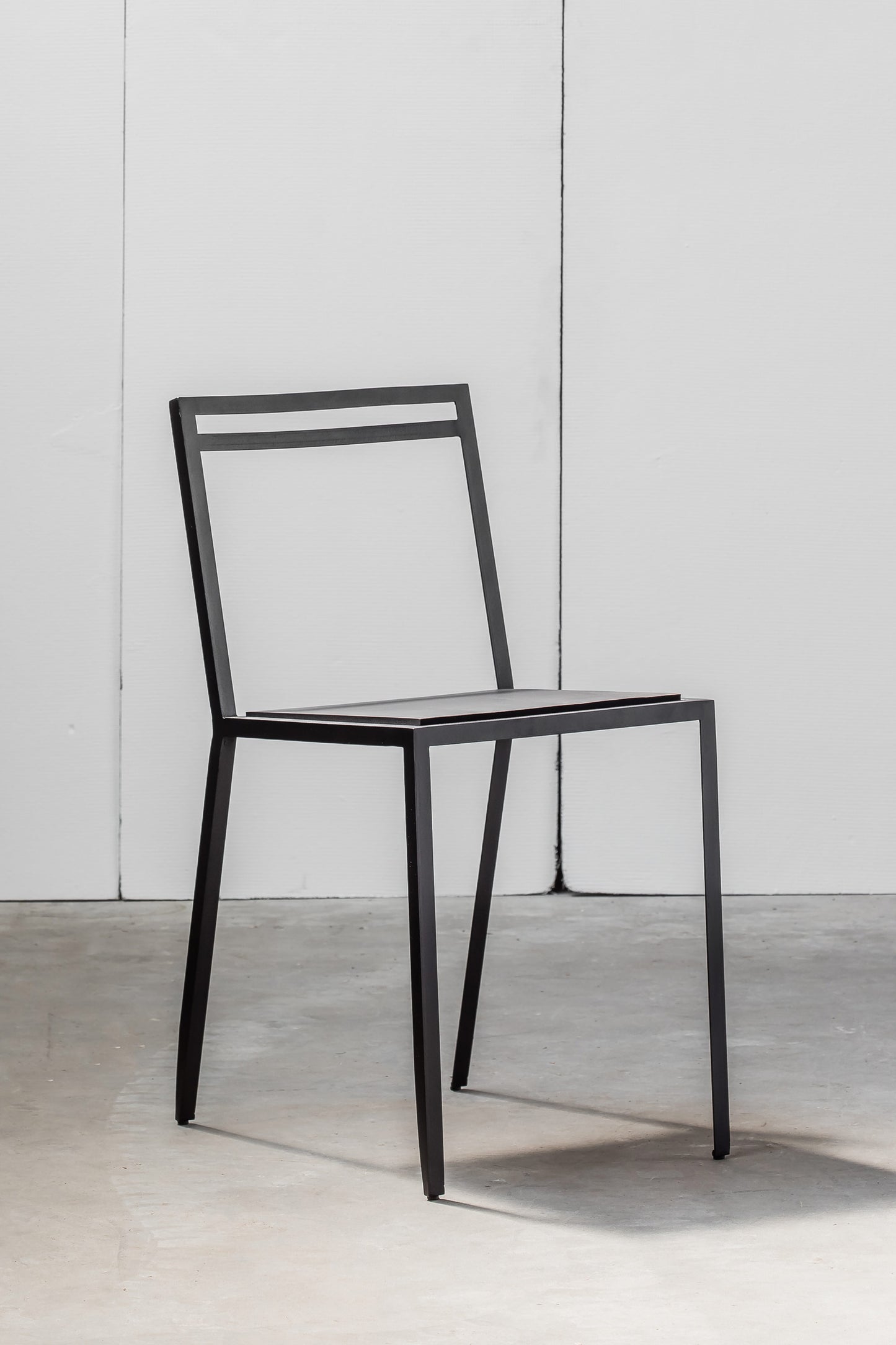 Rubber Chair by Heerenhuis made from black hand-welded metal and thick rubber for seating.