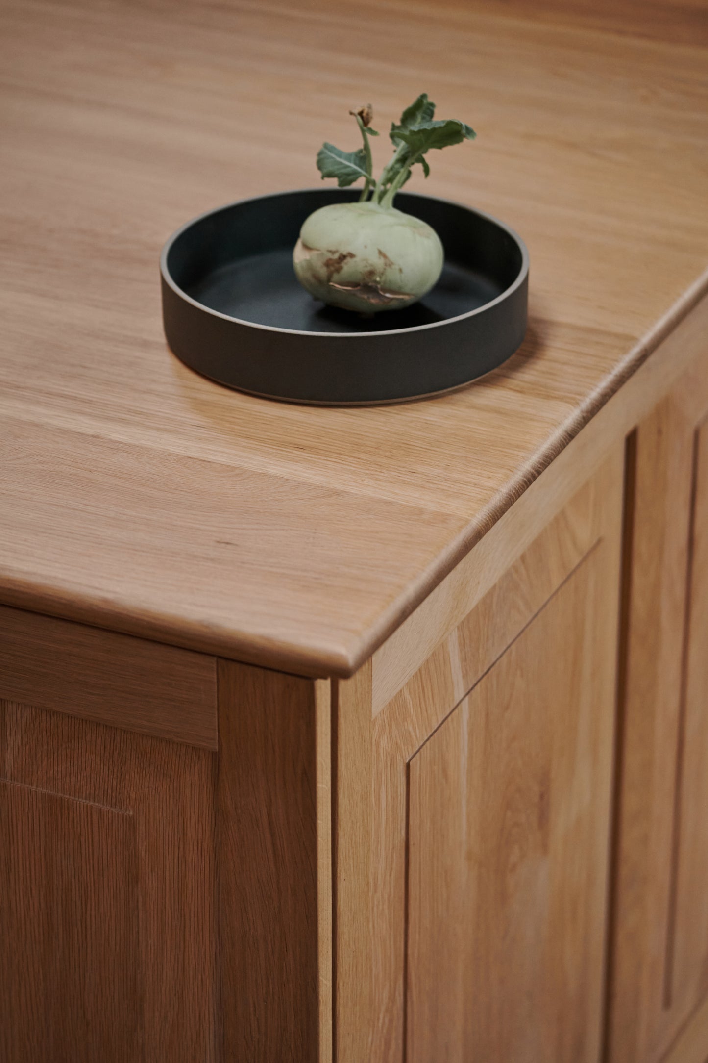 Black Ceramic Stackable Raised Bowl by Hasami Porcelain. Japanese style design, here seen on a wooden table.