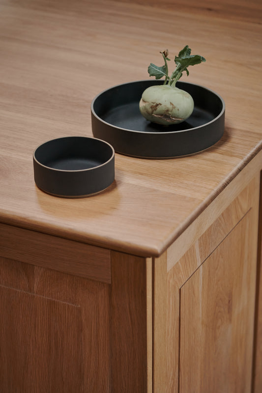 Black Ceramic Stackable Raised Bowls by Hasami Porcelain. Japanese style design, here seen on a wooden table.