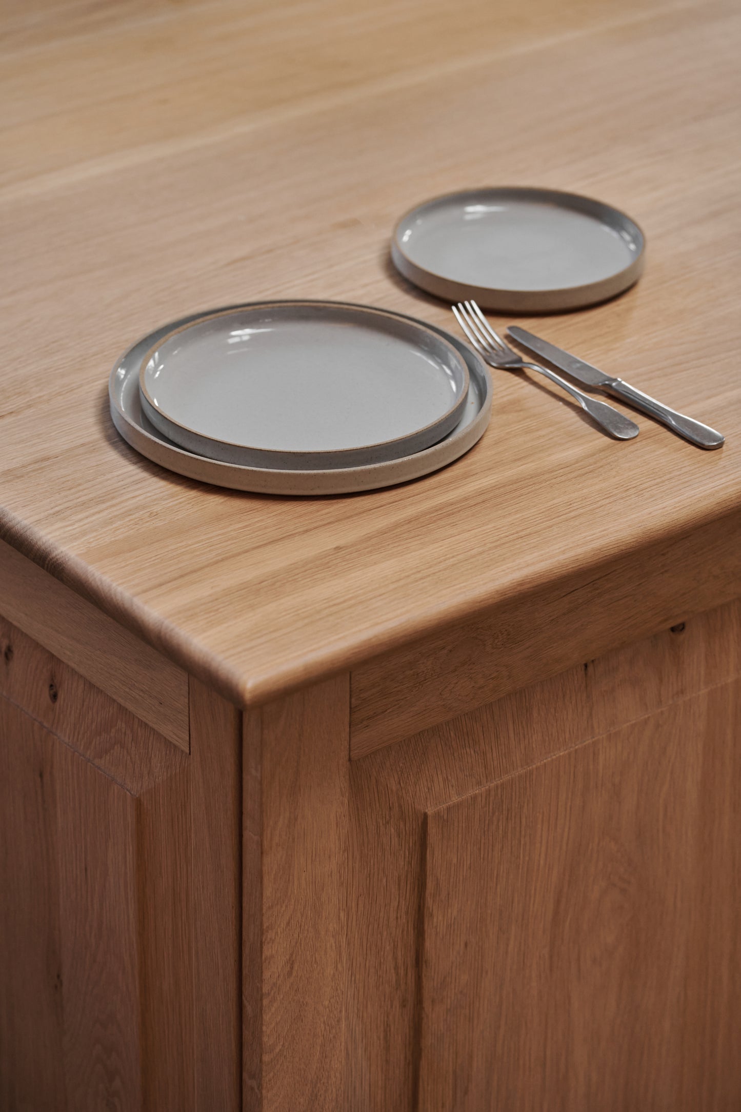 Grey Ceramic Stackable Plates by Hasami Porcelain. Japanese style design, here seen with cutlery on a wooden table.