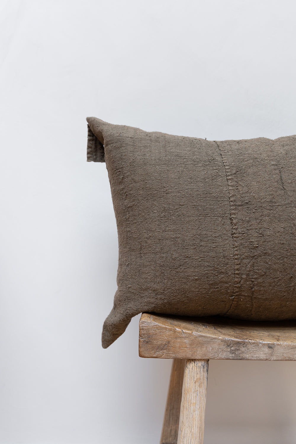 Details of handmade linen grey cushion.