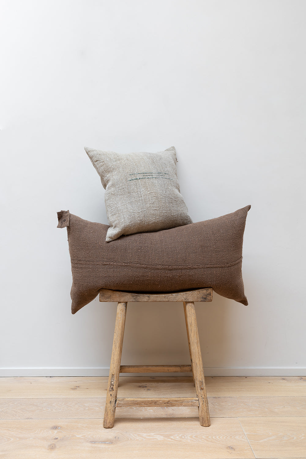 Two cushions by Isasbelle Yamamoto set on a Japanese style design stool.
